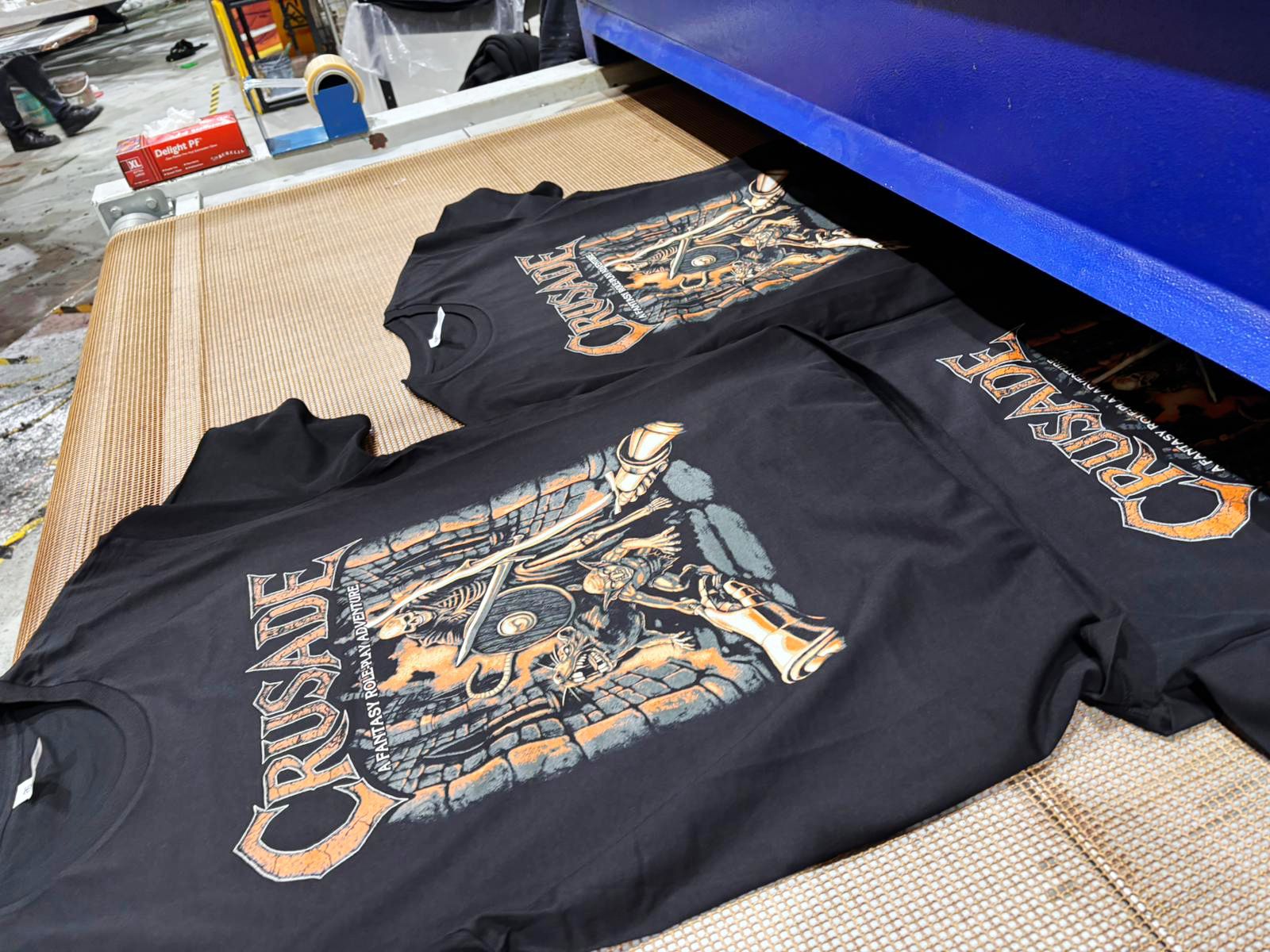 Printed garments leaving the conveyor dryer